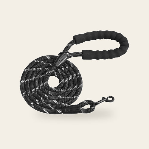6 ft black rope dog leash with reflective threads, padded handle and swivel snap hook on a plain sand background