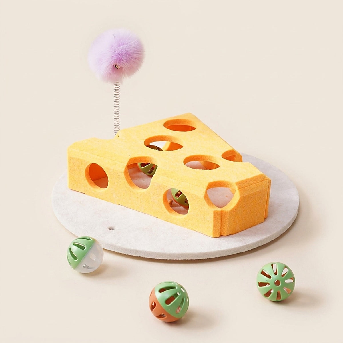 Yellow felt cat treat puzzle box on its base with spring wand and balls