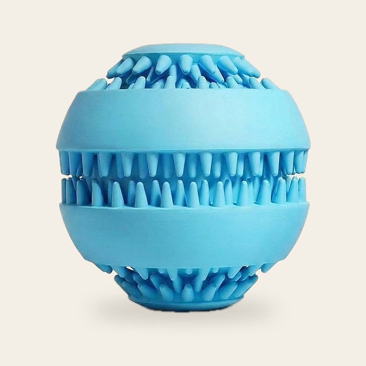 Blue treat-dispensing chew ball for dogs on a plain sand background